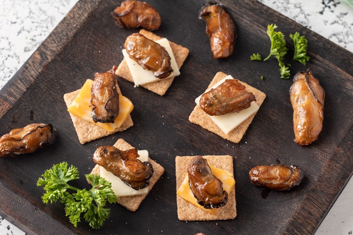 A plate with crackers and cheese on it, perfect for a feast or seven fishes celebration.