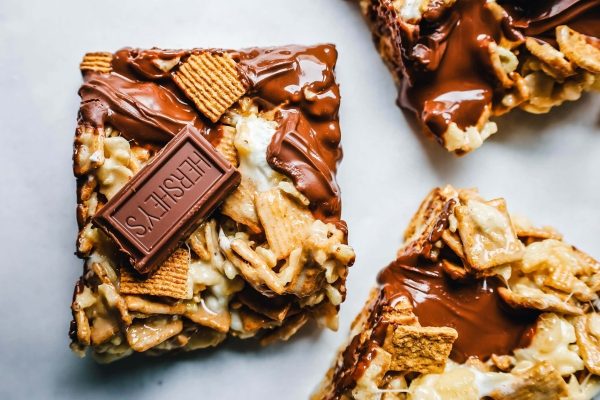 Cheesy granola bars on a white surface.