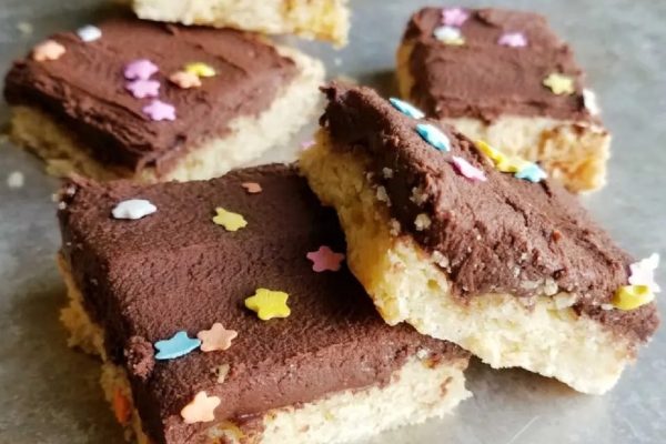 A stack of chocolate bars with sprinkles on top.