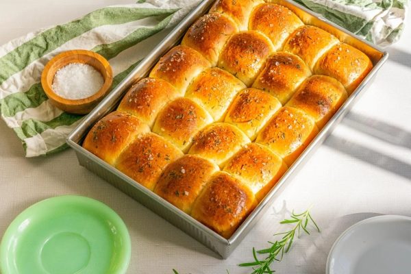 A cheap loaf of bread in a pan on a Thanksgiving table.