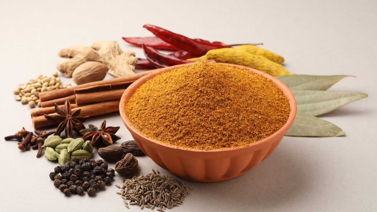 Herbs and spices in a bowl on a table.