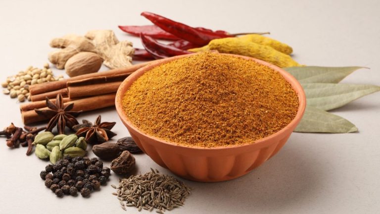 Herbs and spices in a bowl on a table.