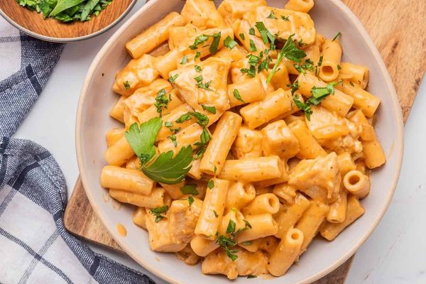 A chicken pasta recipe garnished with parsley.
