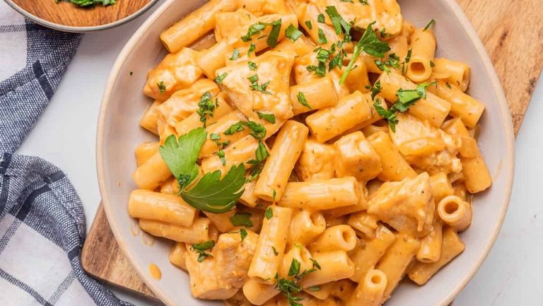 A chicken pasta recipe garnished with parsley.