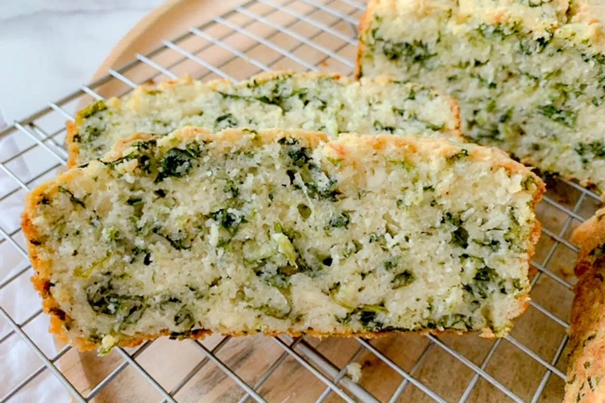 Two slices of zucchini bread from a recipe resting on a cooling rack.