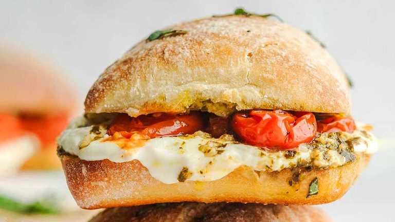 A stack of bruschetta with tomatoes.