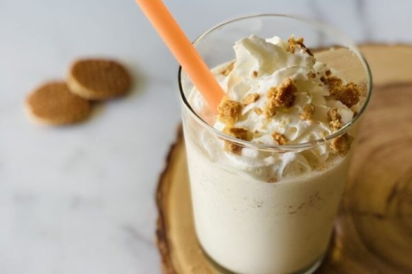 A milkshake with whipped cream and a straw. Looking for milkshake recipes? Look no further! Enjoy this refreshing treat topped with fluffy whipped cream, perfect for sipping through a straw.