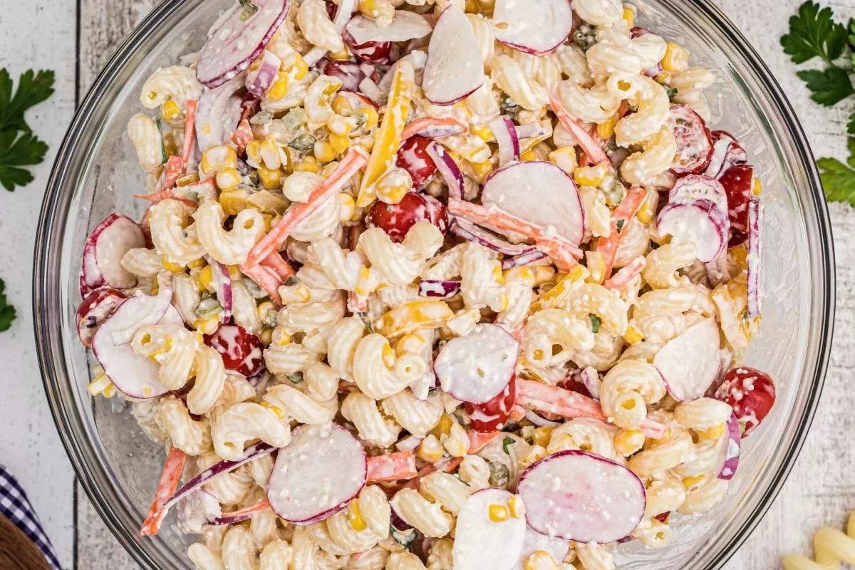 An Italian pasta salad with radishes and corn.