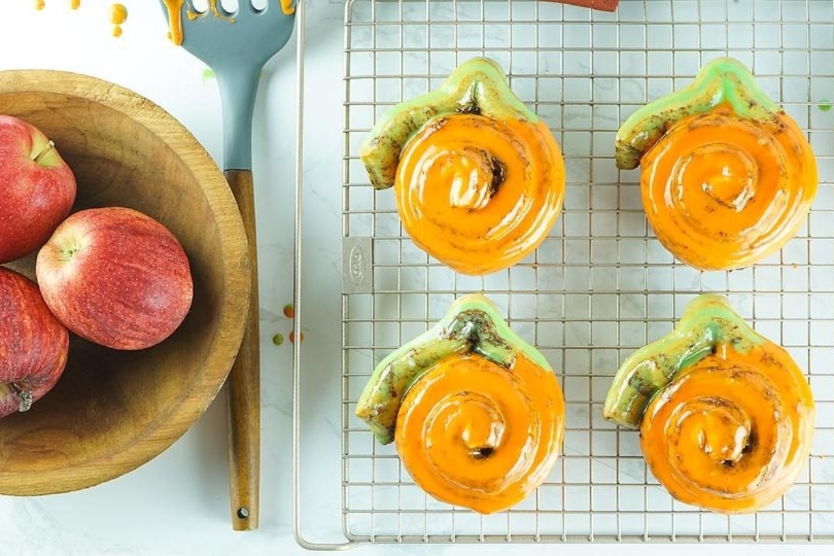 A rack of Cinnamon Rolls overloaded with apples.