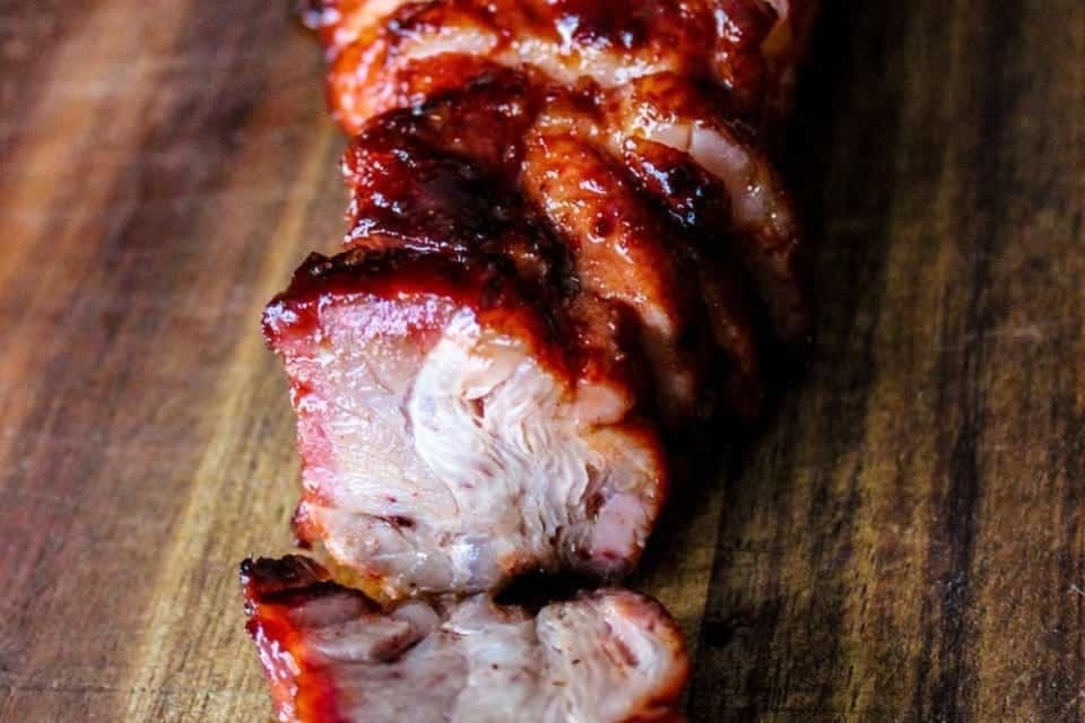 Grilled bbq pork ribs on a wooden cutting board.