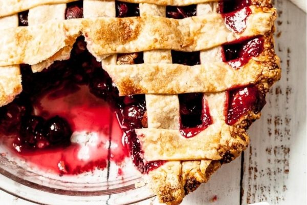 A pie with a lattice crust and berries.
