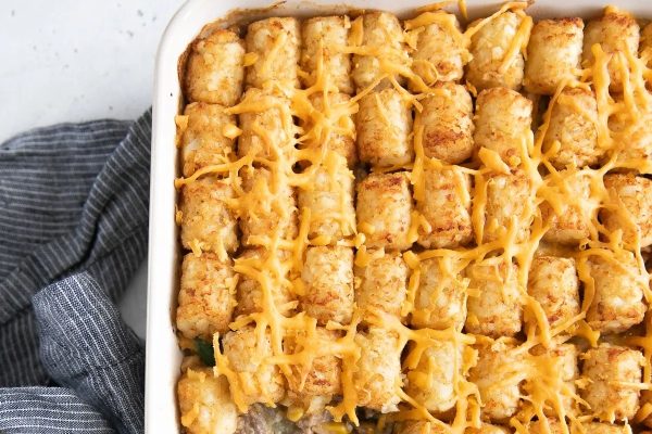 Cheesy tater tot casserole in a baking dish.