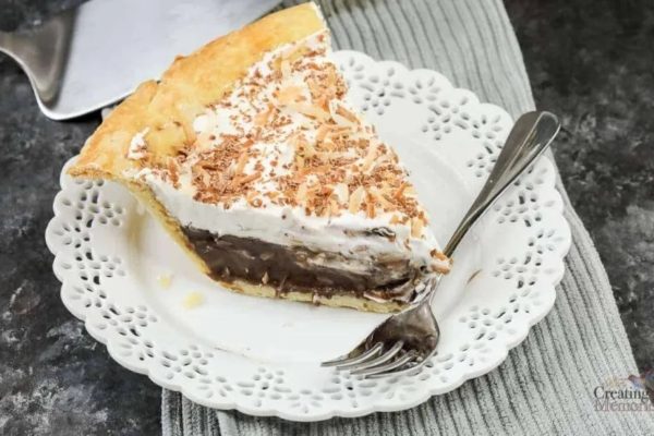 A slice of chocolate coconut pie on a plate.
