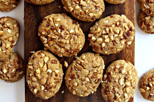 Peanut butter cookies on a wooden cutting board.