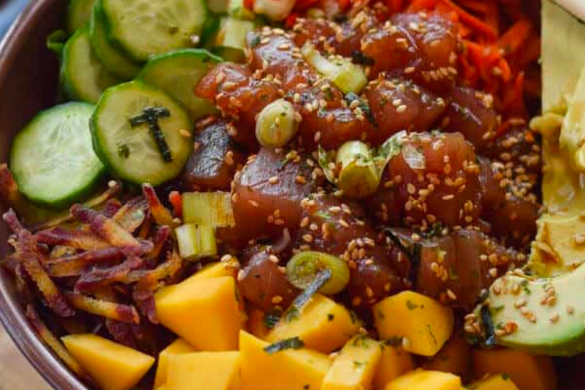 An inspired bowl of Hawaiian food on a wooden table at a luau.