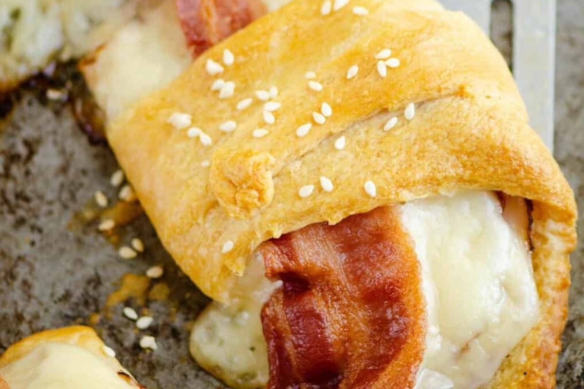 A savory crescent roll filled with bacon, cheese, and sesame seeds.