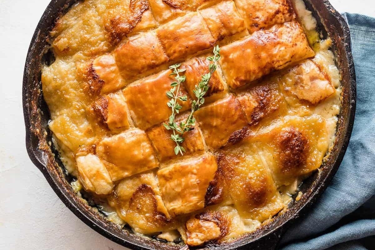 Leftover Turkey Recipes made in a cast iron skillet with a dish of mashed potatoes.