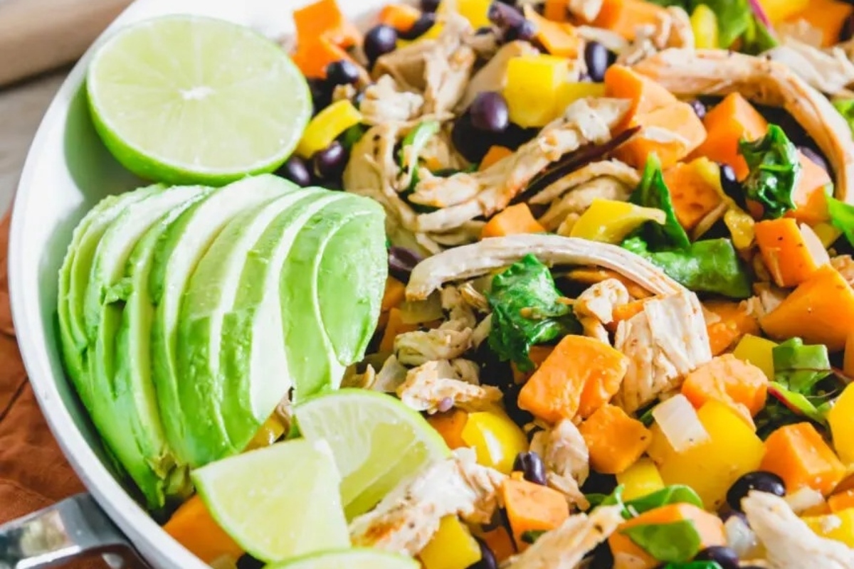 Leftover turkey and sweet potato stir fry in a skillet.