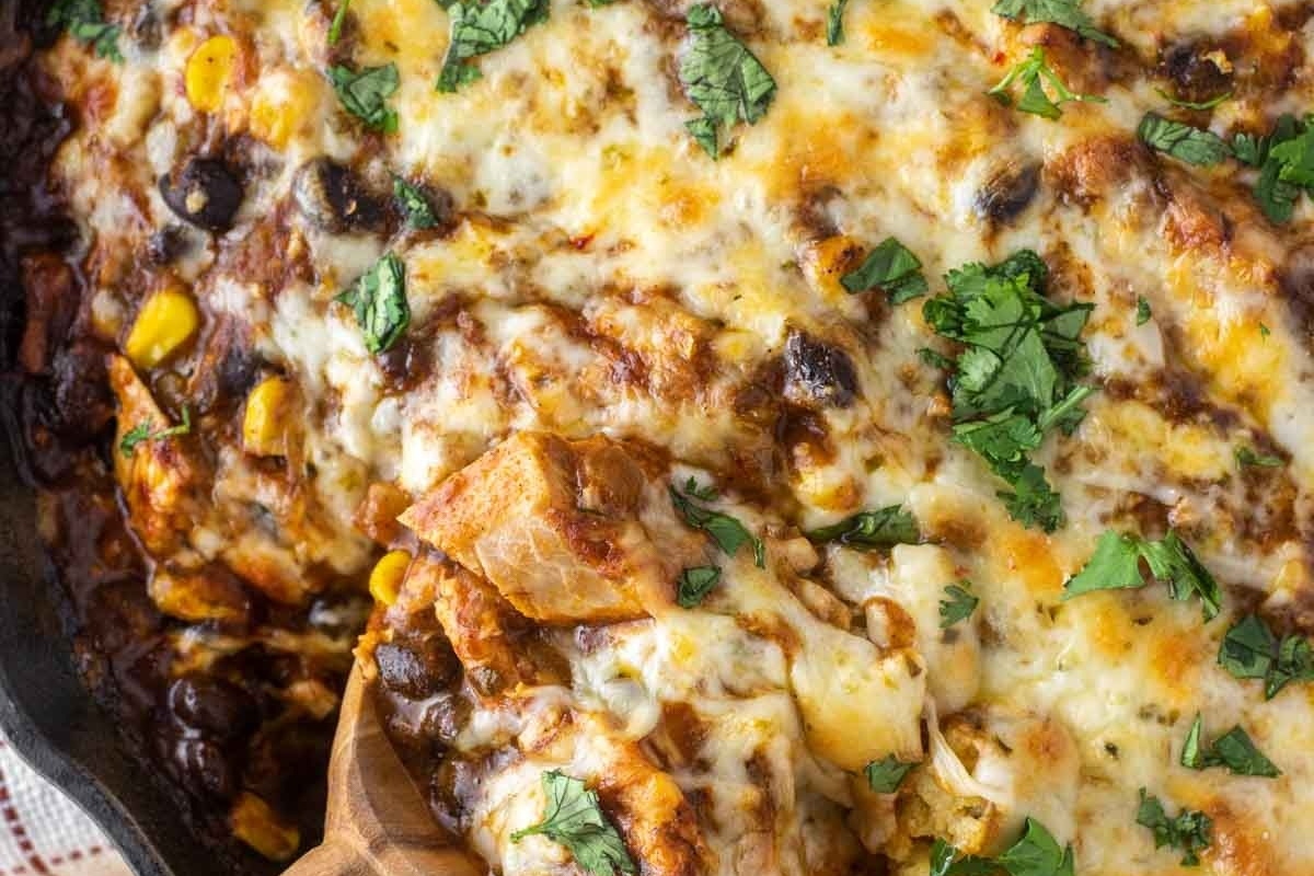 Leftover turkey enchilada casserole in a skillet.