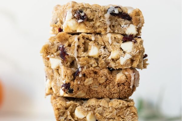 A stack of oatmeal bars with cranberries and oats.