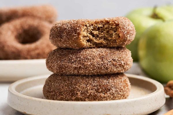 A stack of cinnamon sugar donuts on a plate.
