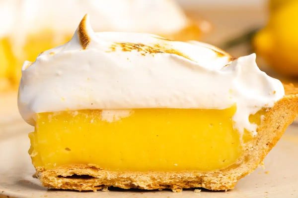 A slice of lemon pie with meringue on top.
