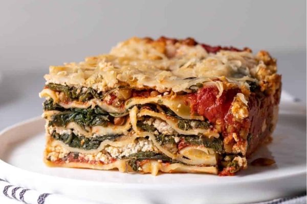 A slice of lasagna on a plate.