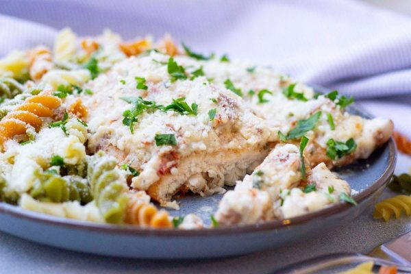 Delicious chicken parmesan casserole served on a plate, combining the perfect blend of tender chicken, savory pasta, and melted cheese.