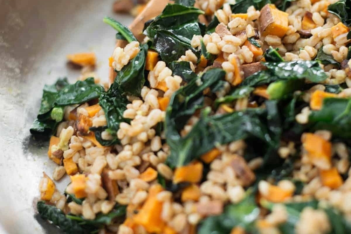 Thanksgiving recipe: Farro with sweet potatoes and kale in a skillet.