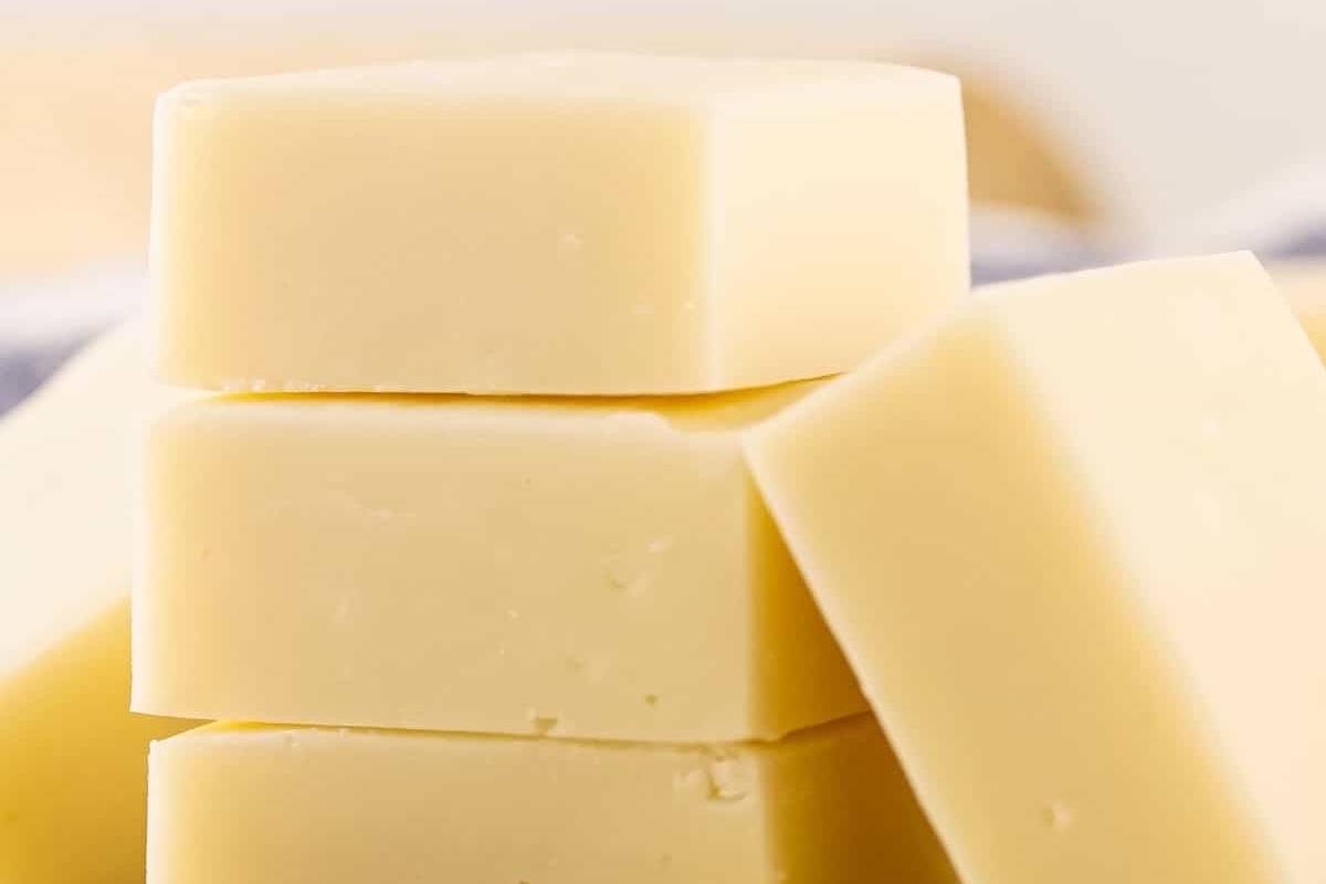 A stack of blocks of butter on a table, perfect for your white chocolate recipe.