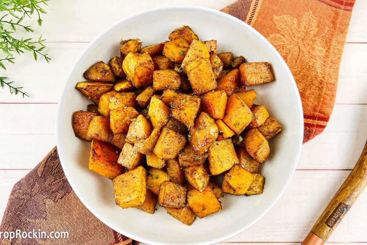 Roasted sweet potatoes served in a white bowl.
