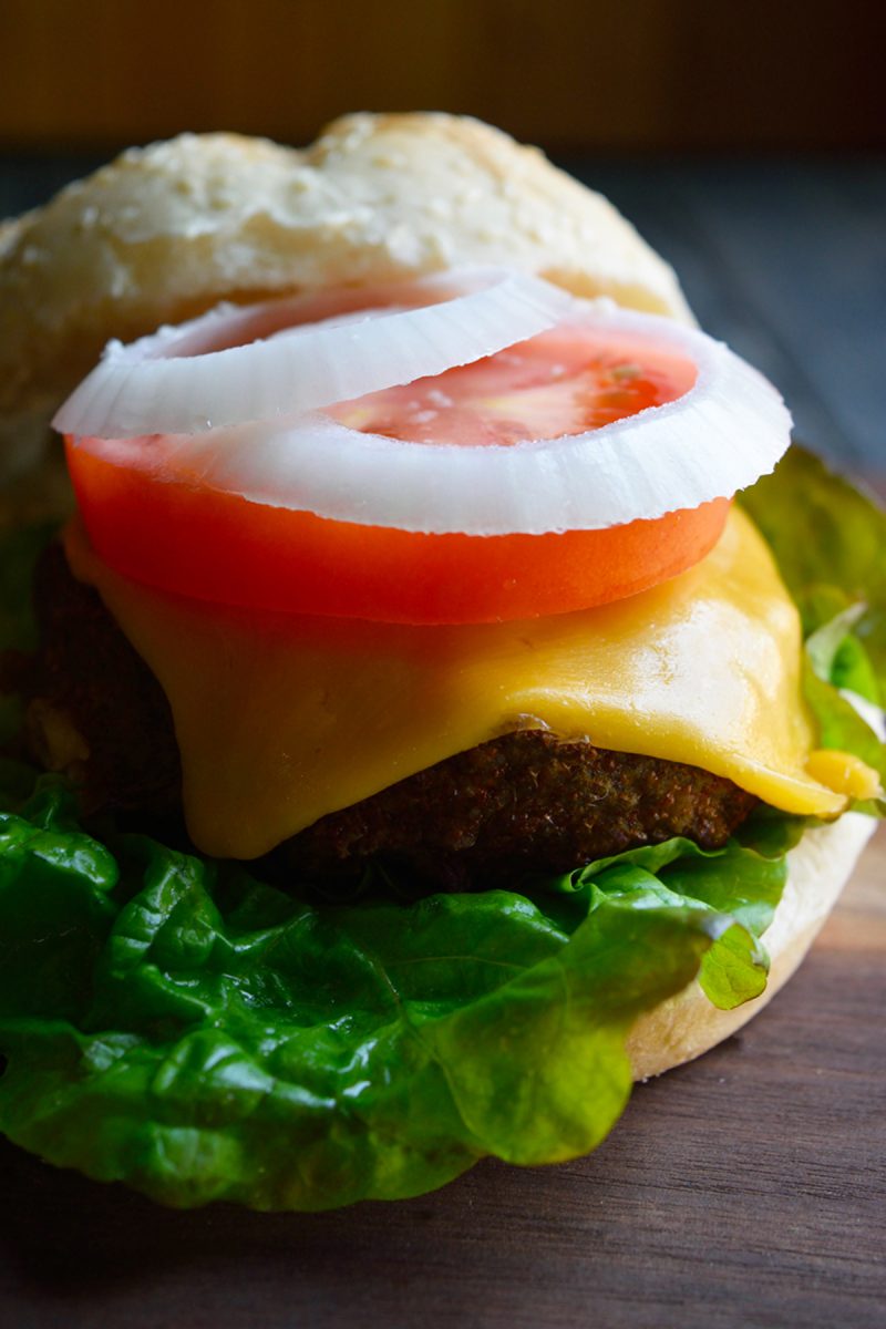 Delicious air fryer turkey burgers on a rustic wooden cutting board.
