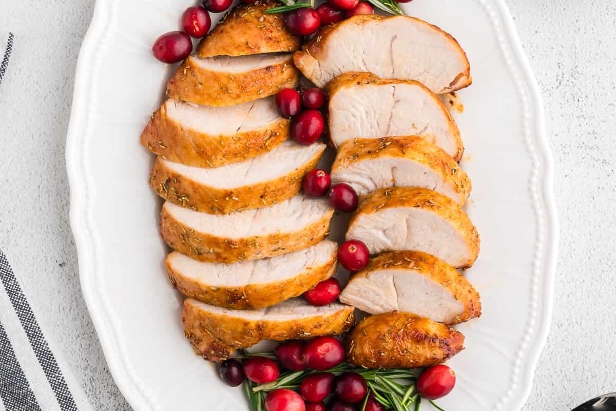 Air-fried sliced turkey with cranberries on a white plate.