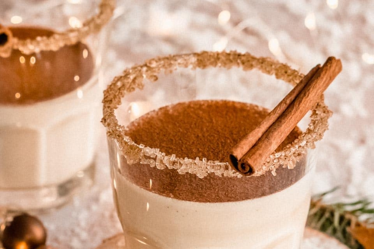Two glasses of hot chocolate with cinnamon.
