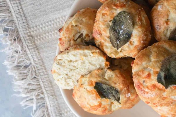 A plate of cheap biscuits with sage leaves on it for a potluck.