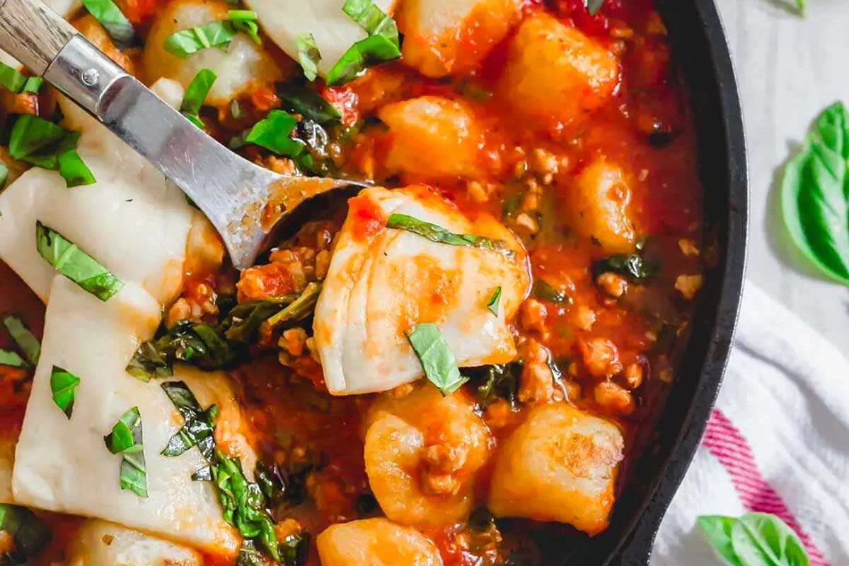 A skillet full of Gnocchi pasta and sauce.