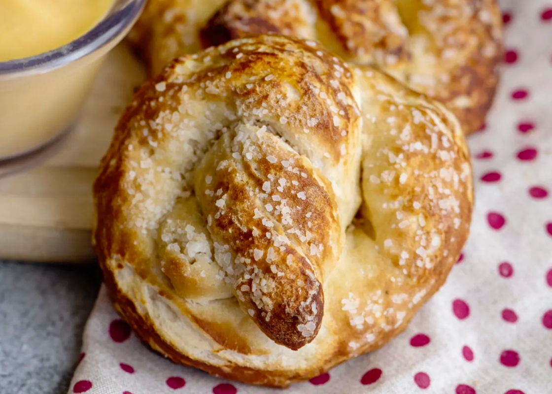 Country style pretzels with mustard on a polka dot background.