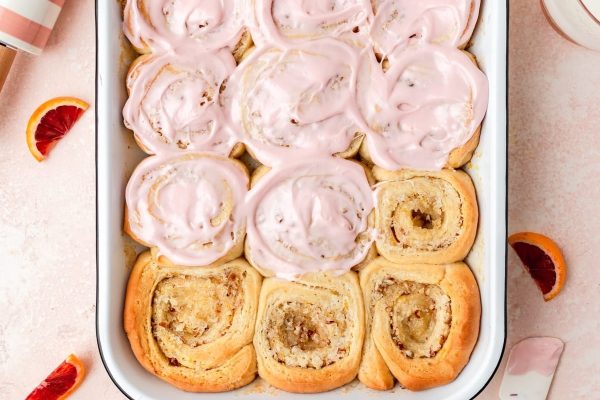 Cinnamon rolls filled with the tangy sweetness of blood oranges baked in a dish.