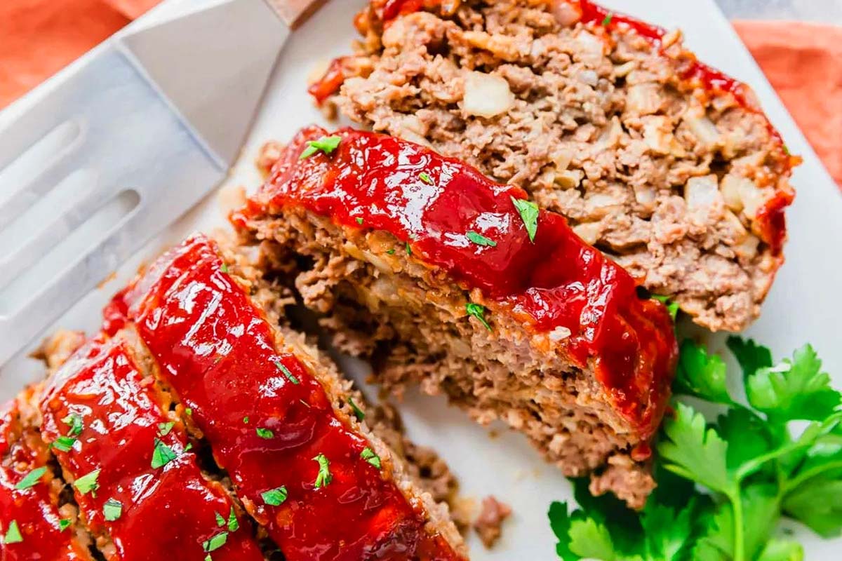 A delectable slice of meatloaf on a classic white plate.