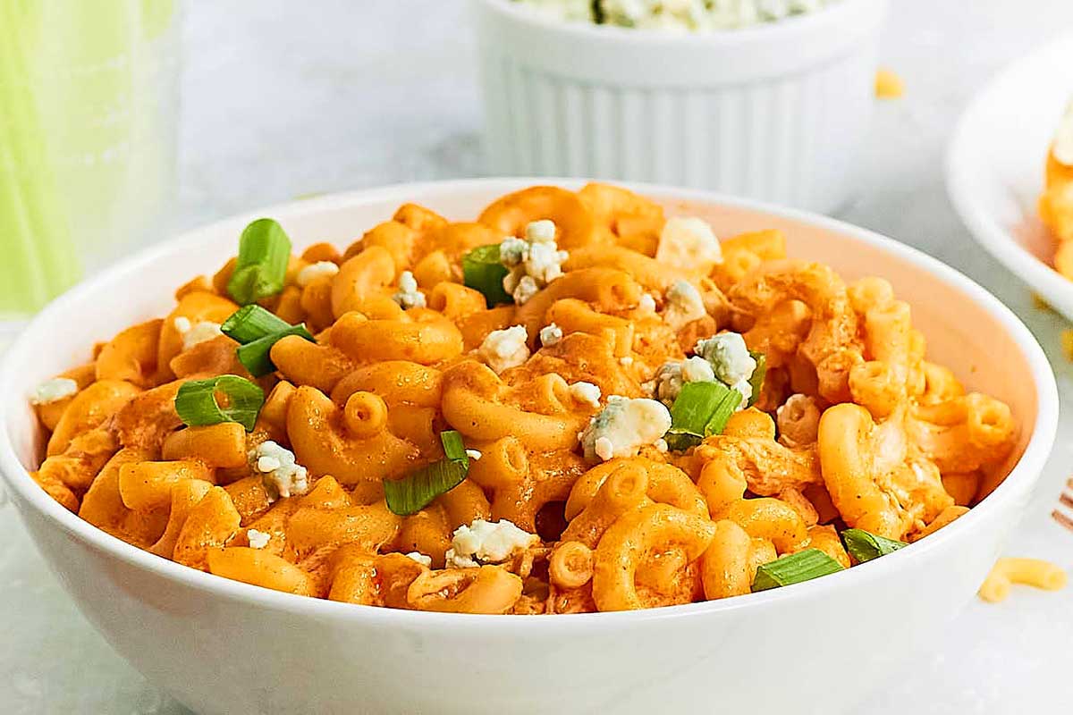 Buffalo chicken macaroni and cheese in a white bowl.