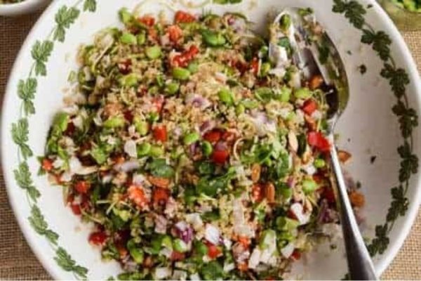 A colorful salad with vegetables and peas.