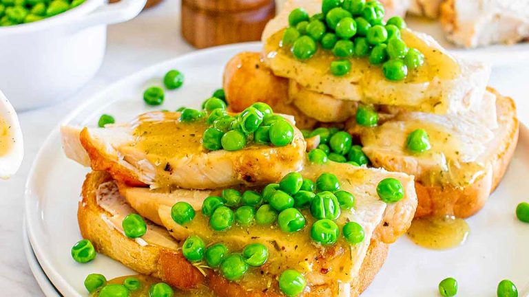 A plate of pub food featuring bread and peas.