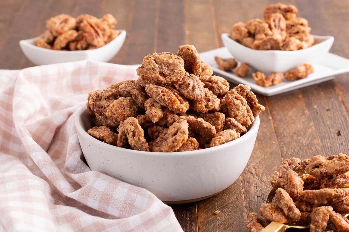 Delicious pecans in a bowl on a rustic wooden table.