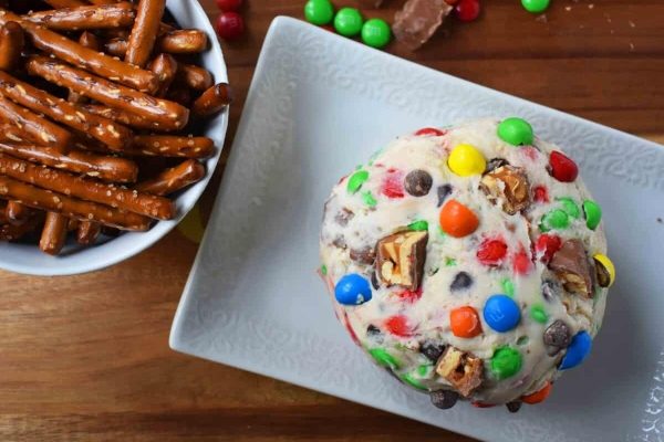 A plate with pretzels and m&m's, perfect for a party snack or indulgent treat.