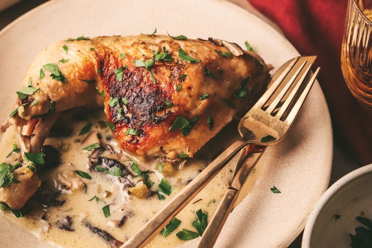 A plate with turkey and mushrooms on it, perfect for Thanksgiving mains.
