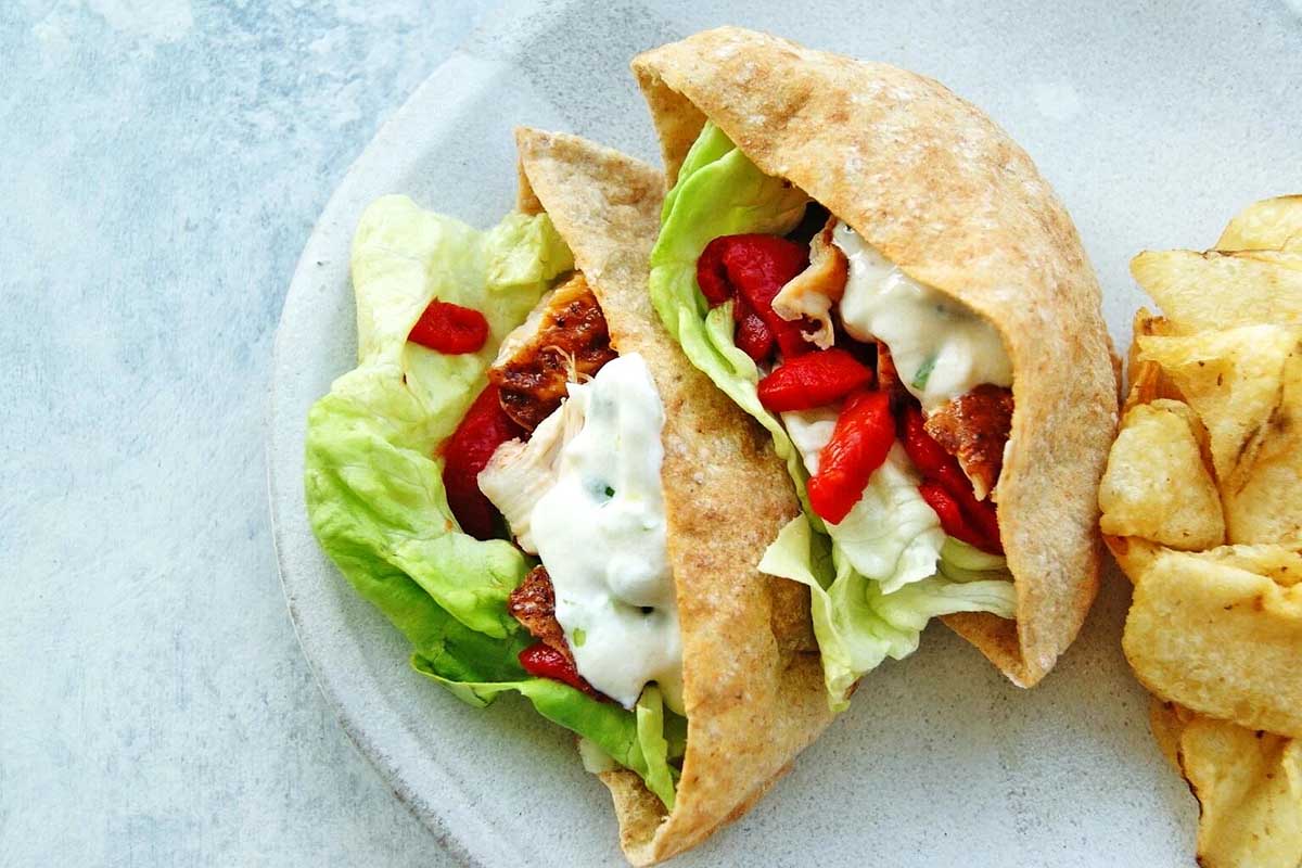 A plate with pitas and chips on it.