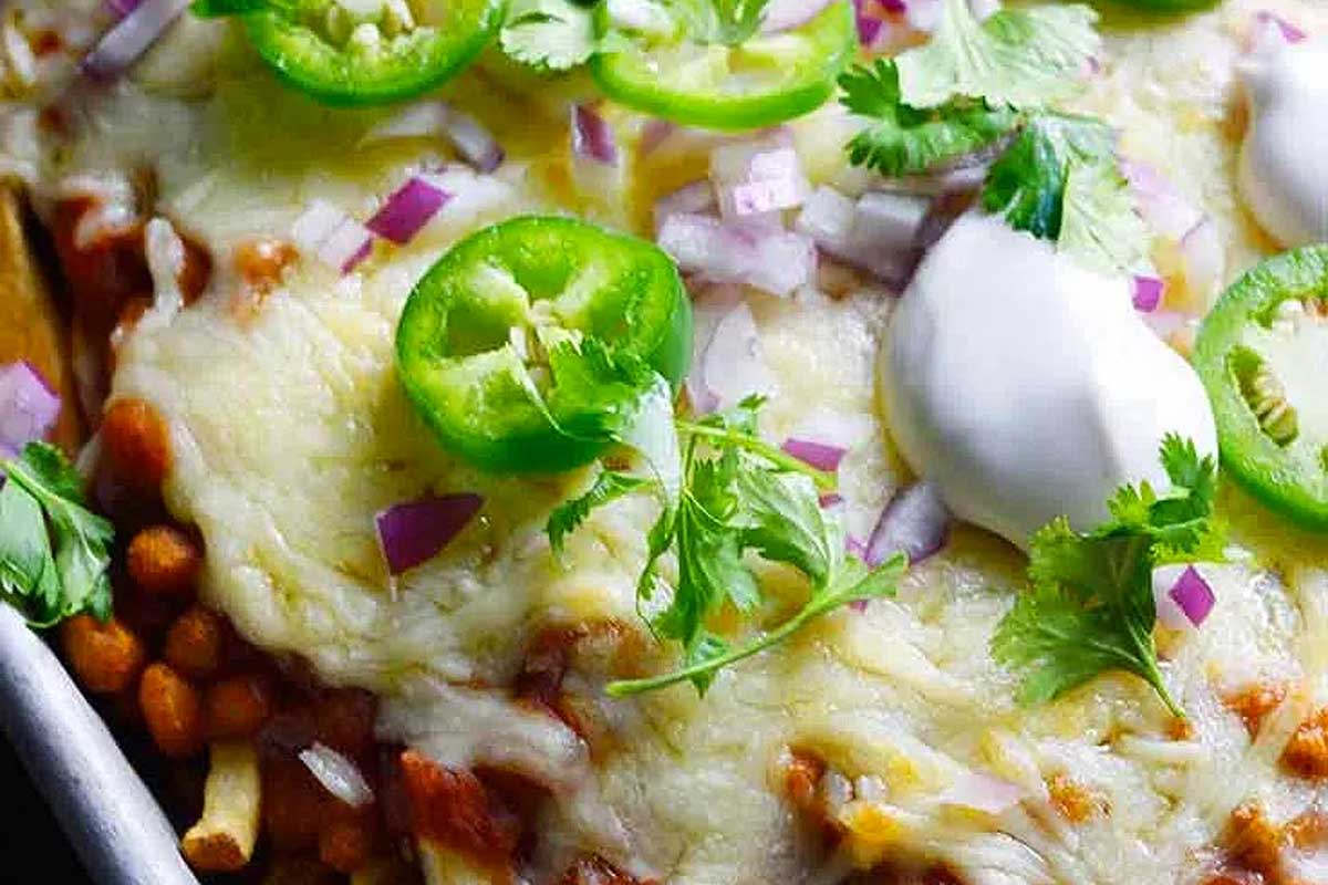 A casserole dish with beans, cheese and sour cream.