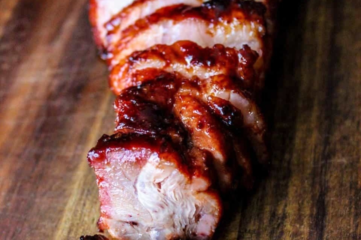 Not Turkey Thanksgiving Mains featuring bbq pork ribs on a rustic wooden cutting board.