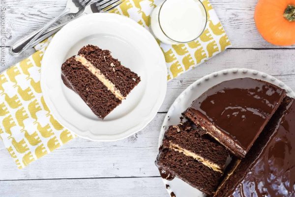 A slice of chocolate cake with peanut butter frosting on a potluck plate.