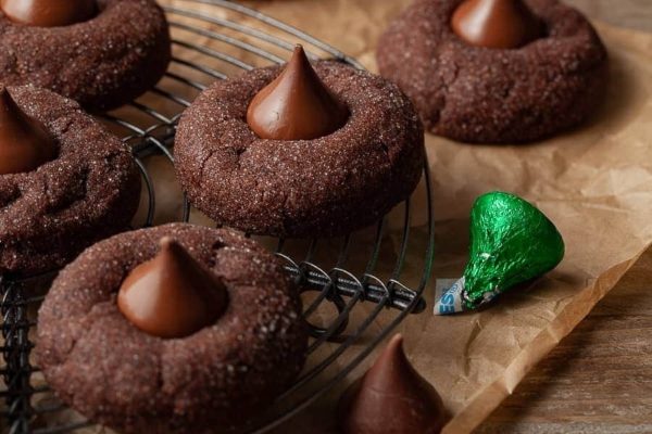 Chocolate cookies with chocolate kisses on a cooling rack.